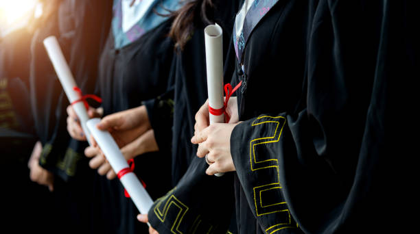 istock Graduated students holding diplomas in a line 1772126958