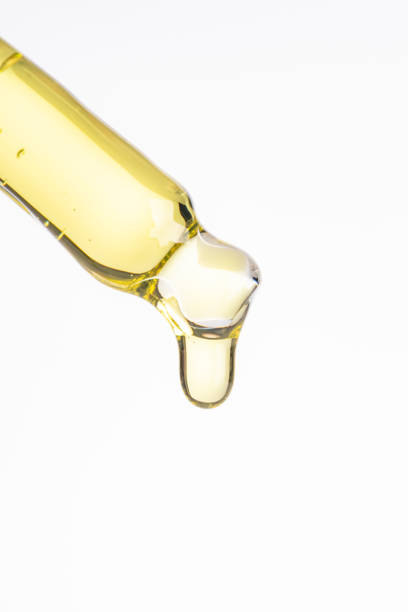 istock Cosmetic pipette with a yellow oily drop close up on white background ,macro 1772127500