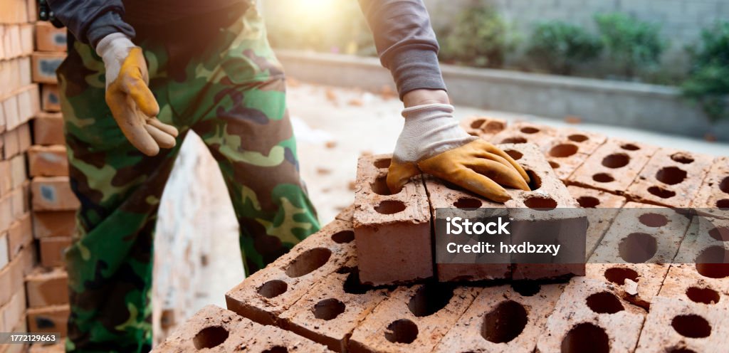 Bricklayer Projects Bricklayer With Brick At Construction Site Stock Photo - Download Image ...