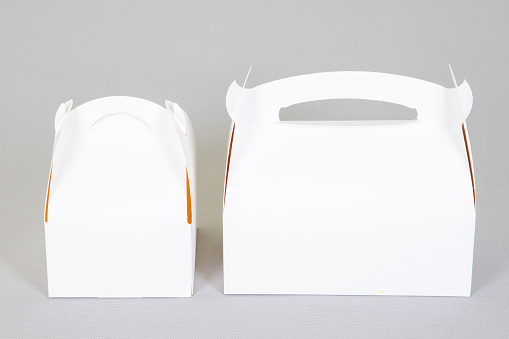 two white boxes mockup blank paper packaging for bakery box empty sign with handle in grey background