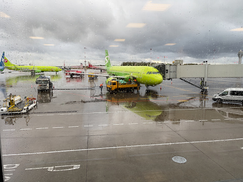 Novosibirsk, Siberia, Russia - October 04, 2023.
Boarding a flight in rainy weather. Airplane of the company s7.