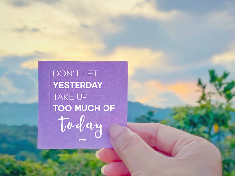 Inspirational motivational Quote Concept - don't let yesterday take up too much of today with blurry nature background.