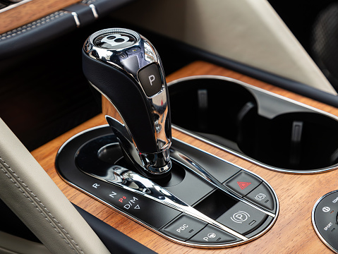Novosibirsk, Russia -  November 03  , 2023: Bentley Bentayga ,    Close up of the manual gearbox transmission handle. Accelerator handle and buttons in a new car.