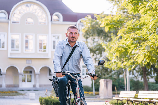 Businessman riding bicycle in the city.