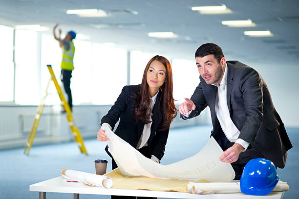 istock business partners discuss the new layout for their office interi 177219667