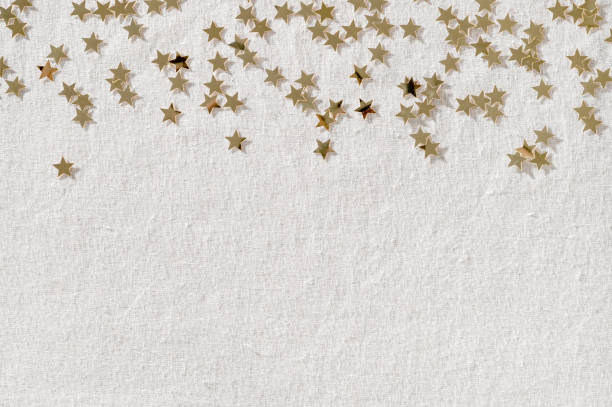 istock Festive party celebration background with copy space, gold star confetti border on neutral beige linen fabric texture. Winter holiday announcement, advertising design template for business brand 1772218993