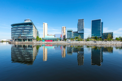 Wide angle view of modern architecture at Salford Quays on a clear summers day.