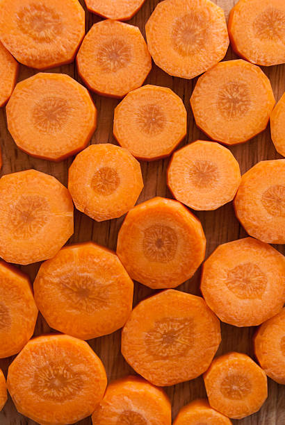 istock Chopped carrot circles against wood 177223387