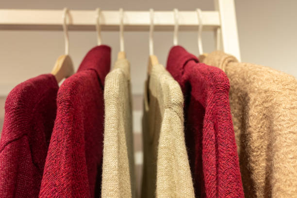istock selective focus, fine wool sweaters hung on hangers in a store 1772245544