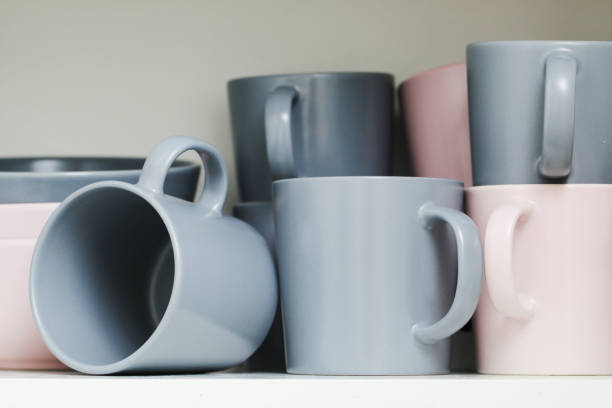 istock Coffee mugs stacked background. Ceramic mugs on white shelf. Coffee time background. 1772248486