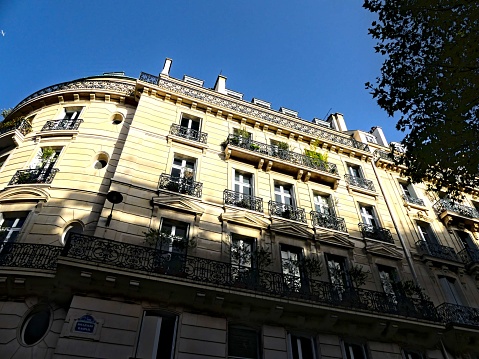 Paris, Octobre 2023 : Visit of the magnificent city of Paris, Capital of France - View on different facades of buildings built by Baron Haussmann