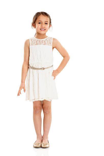милая маленькая девочка в красивом платье - little girls pre adolescent child standing isolated стоковые фото и изображения