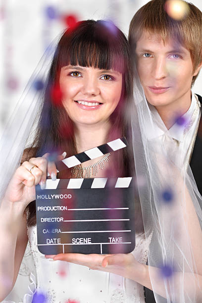 istock Bride and groom look at camera behind transparent curtain 177226842