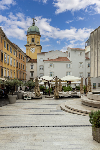 Rijeka, Croatia - September 23, 2023: Kobler Square Fountain, baroque city clock tower in a distance
