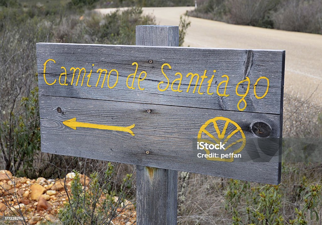 Sign on Way of St James Yellow arrow sign painted on a wooden shield on Camino de Santiago Arrow Symbol Stock Photo