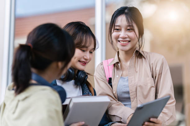 istock University students reading text on tablet and tutoring special class while walking to next class 1772284847
