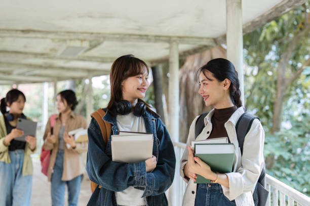 istock University students reading books and tutoring special class while walking to next class 1772284882