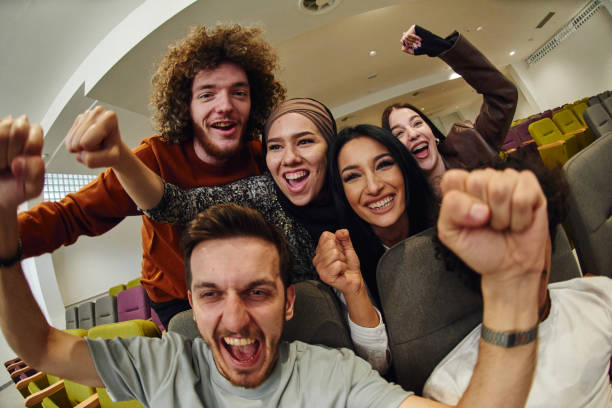 istock A diverse group of young people exuberantly celebrates and cheers while watching a soccer match, radiating excitement, unity, and sportsmanship 1772301447
