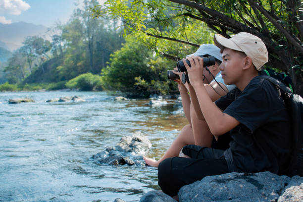 istock Asian boys with binoculars at national park 1772303647