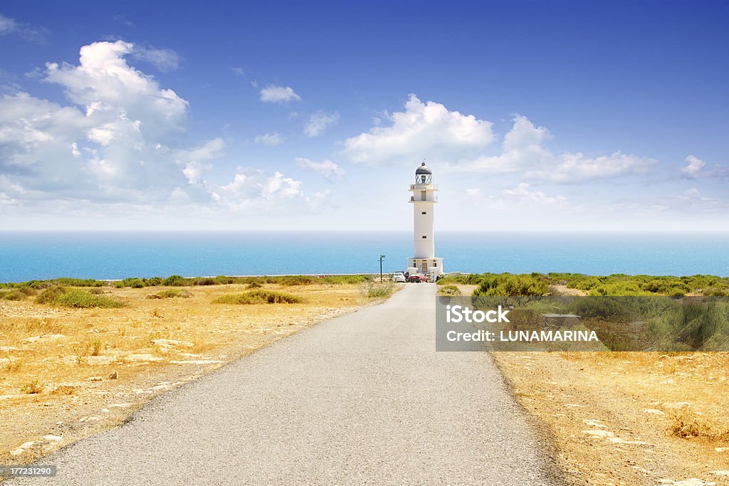 Barbaria cape lighthouse in Formentera Barbaria cape lighthouse in Formentera with road perspective Formentera Island Stock Photo