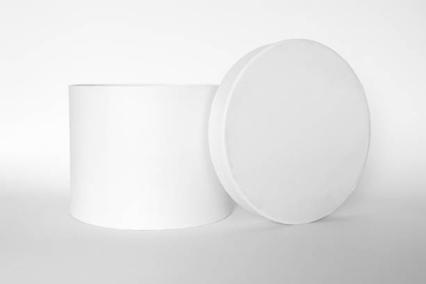 istock Single blank textured round box, gift with rope and its lid lean on it isolated on light white background. Mockup With shadow 1772315645