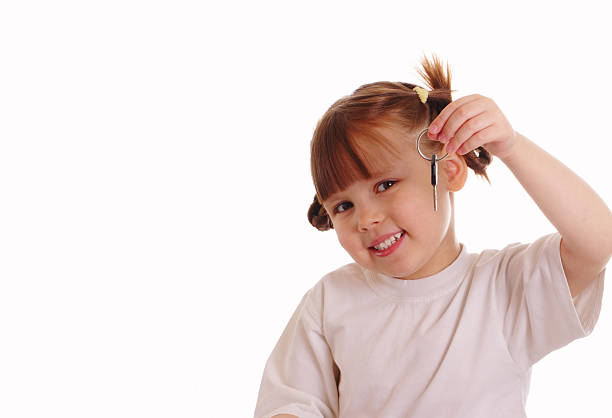 Little girl holds a key stock photo