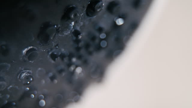 Slow motion of water flow falling drop from the shower head in the bathroom.