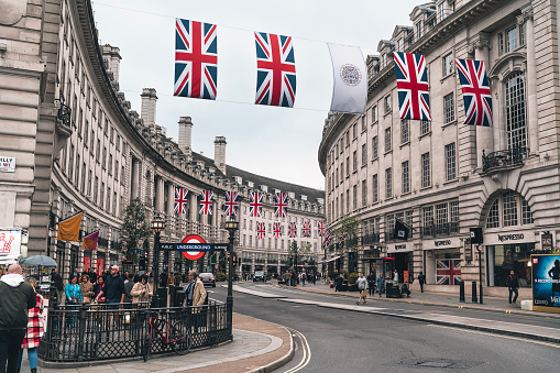 London, UK - June 22, 2018: High angle view of Piccadilly Circus Regent street with cars on street traffic road with banners hanging for the Ritz hotel