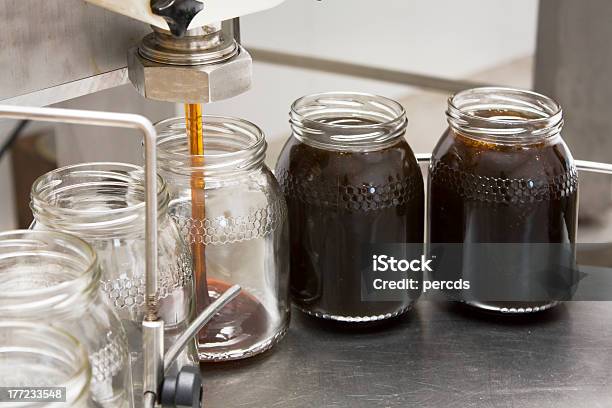 Pouring Honey Into Storage Jars Stock Photo - Download Image Now - Jar, Syrup, Honey