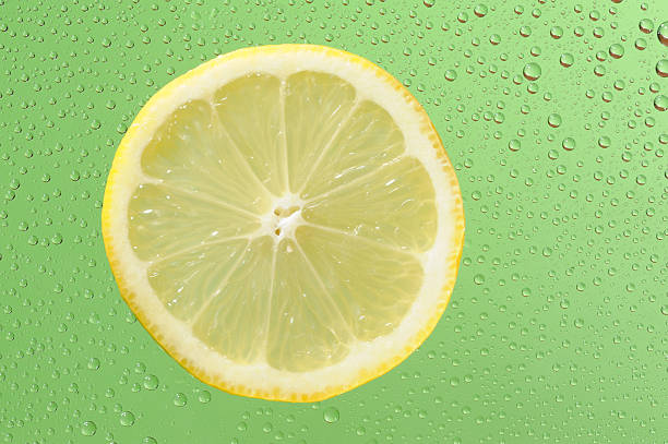 istock Lemon with many water drops on the green background 177233997