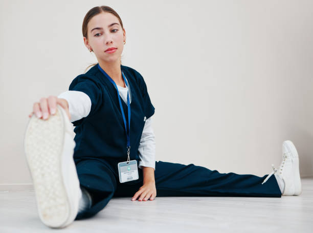 Stretching, legs and nurse with feet on floor in exercise, pilates or start of shift in clinic and healthcare. Work, preparation and warm up body for wellness, meditation and fitness in hospital estiramientos, piernas y enfermería con los pies en el suelo en ejercicio, pilates o inicio de turno en clínica y atención médica. trabajo, preparación y calentamiento corporal para el bienestar, la meditación y el fitness en el hospital