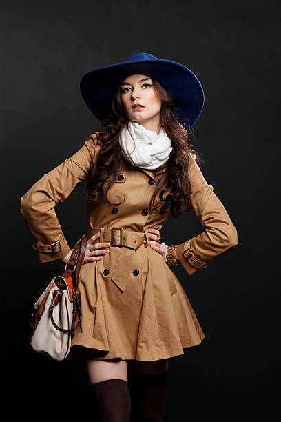 istock woman wearing brown overcoat and cap blue 177234621