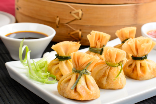 Above view crystal shrimp dumpling in bamboo steamer on beige table runner