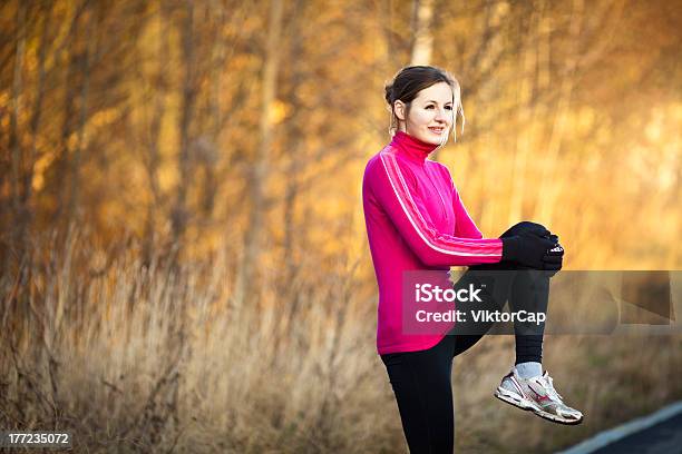 Young Woman Stretching Before Her Run Stock Photo - Download Image Now - Active Lifestyle, Activity, Adult