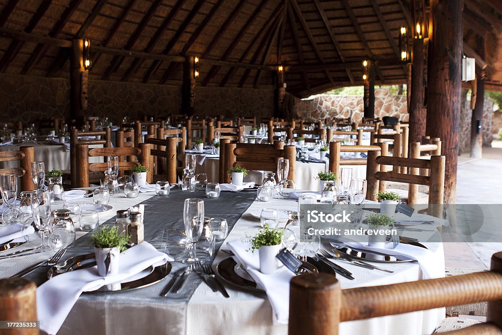 Wedding reception tables and decor Wedding reception decor under thatch roof Dining Stock Photo