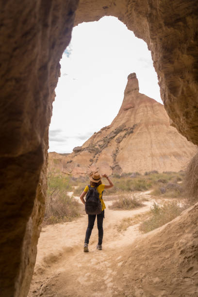 istock Woman in hat walking along a path in the desert 1772354563