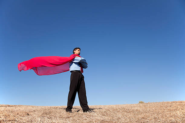 istock Businessman in a red cape standing in the sun 177235867