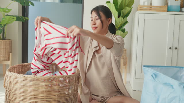Beautiful young Asian woman doing laundry at home. Activity of daily living at house.