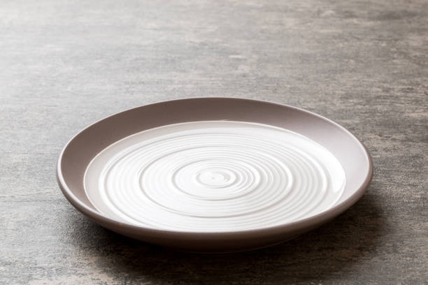 istock Perspective view of empty light plate on cement background. Empty space for your design 1772364697