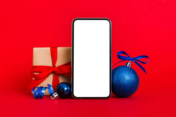 istock Digital phone mock up with rustic Christmas decorations for app presentation with empty space for you design. Christmas online shopping concept. Tablet with copy space on colored background 1772365356