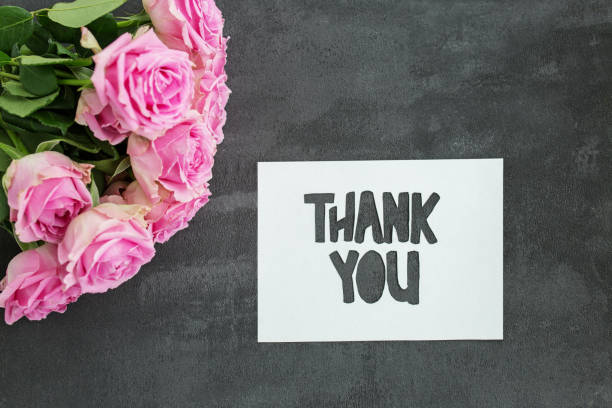 istock Thank you message on gray background with flowers. Background for postcard. 1772365889