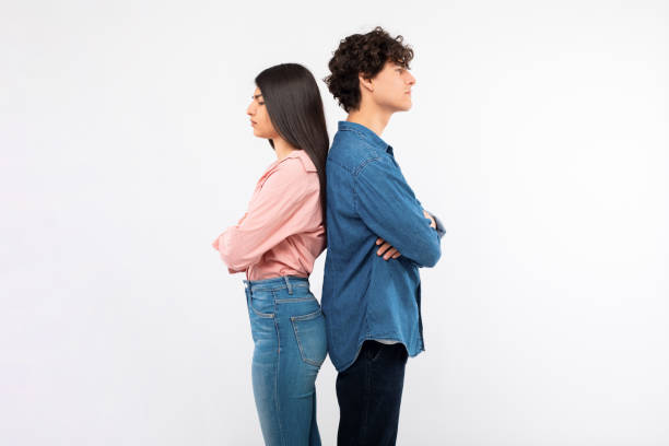 istock Frustrated couple standing back to back sulking on white background 1772369429