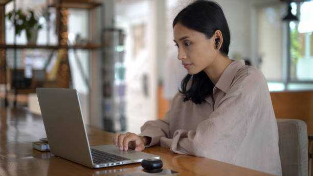 istock Asian girl work computer office. Woman freelancer use mobile phone. Phone cafe. 1772379785