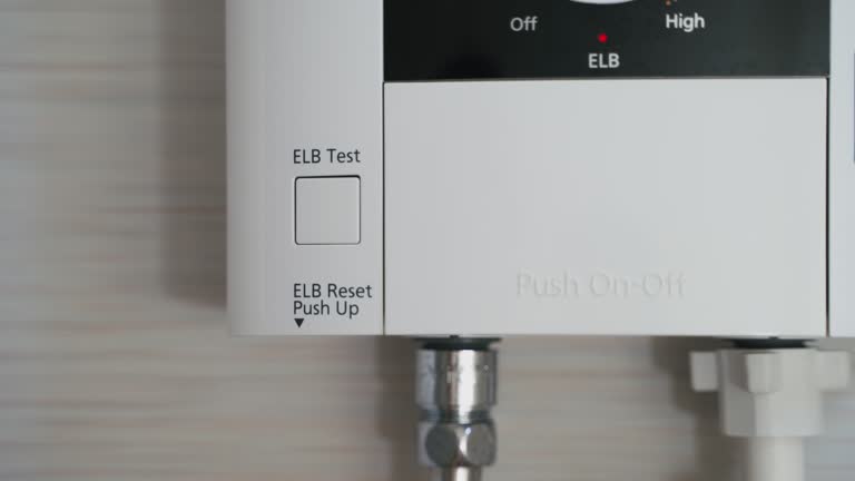 Close up Man’s hand push button ELCB Test for test water heater system for safety. Safety and testy Concept.