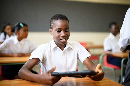 Schoolchildren using digital tablets in the classroom