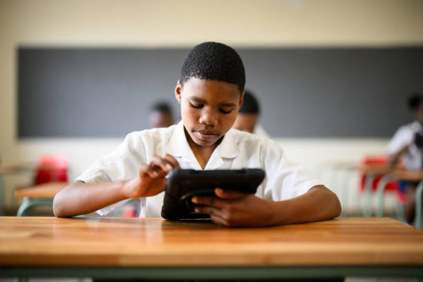 istock Young teenage schoolboy looking down using touchscreen on digital tablet 1772380614