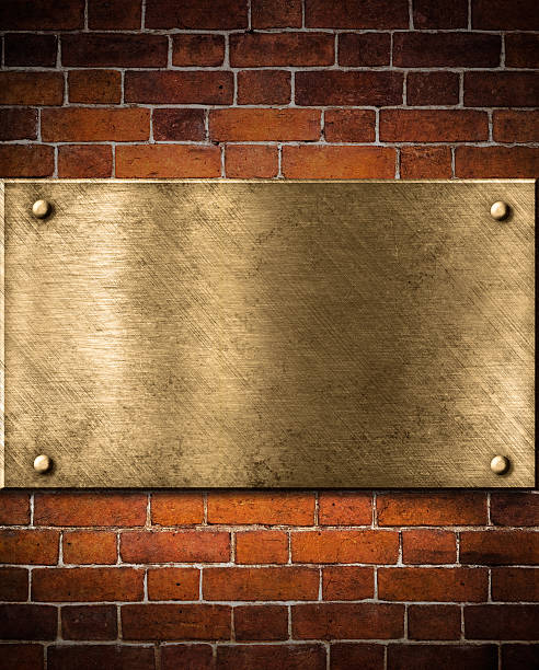 istock old golden or bronze plate on brick wall 177238128
