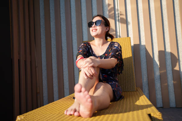 People enjoying the sun on a deck chair