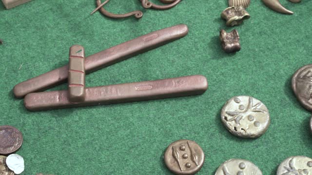 Overview of Ancient Roman coins measuring and writing instruments close up