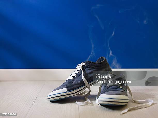 Stinking Wornout Shoes Left On Wooden Floor Stock Photo - Download Image Now - Unpleasant Smell, Shoe, Body Odor